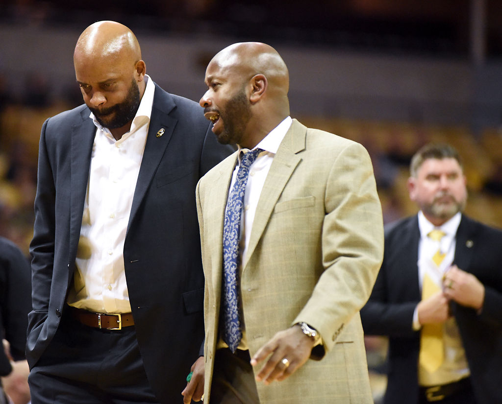 Cuonzo Marin, left, and assistant coach Marco Harris walk off the court at halftime